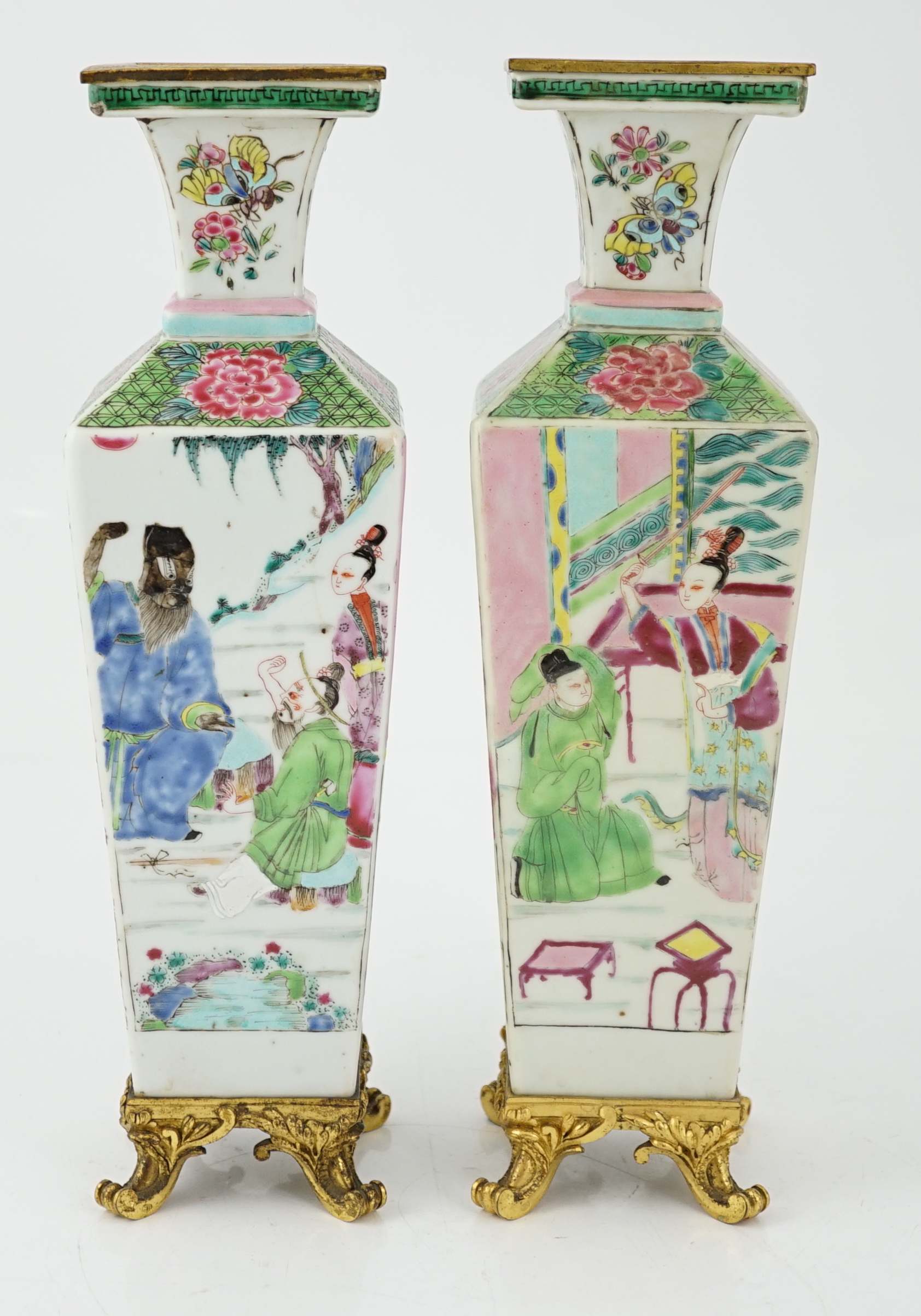 A pair of Chinese famille rose square baluster vases, late 19th/early 20th century, with European gilt metal mounts, each painted with figure scenes, total height 32cm
